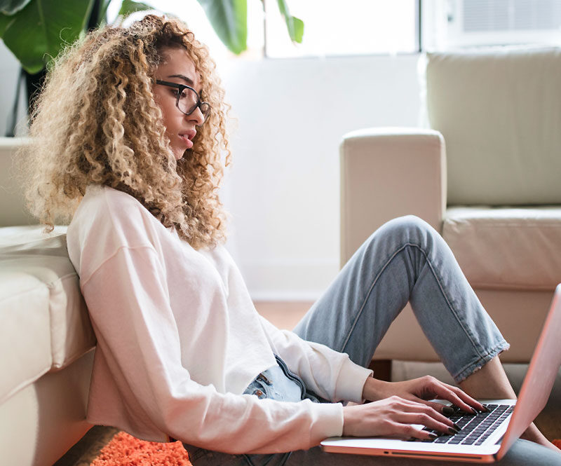 Woman Sitting on Floor Working Woman Sitting on Floor Working